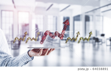 Close of businessman holding tablet pc with progressing graph ic Close of businessman holding tablet pc with progressing graph ic 64038891