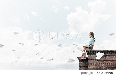 Concept of careless happy childhood with girl and paper plane fl 64039496