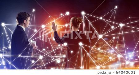 Concept of social connection and networking against night city view and partners working in cooperation Concept of social connection and networking against night city view and partners working in cooperation 64040001