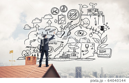 Rear view of businessman on house roof drawing his new business 64040144