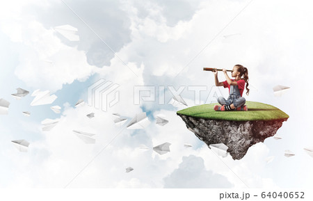Concept of careless happy childhood with girl looking in spyglas Concept of careless happy childhood with girl looking in spyglas 64040652