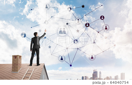 Businessman on house roof presenting networking and connection concept. Mixed media 64040754