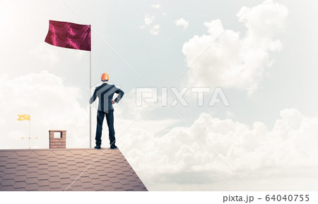 Young businessman with flag presenting concept of leadership. Mi Young businessman with flag presenting concept of leadership. Mi 64040755