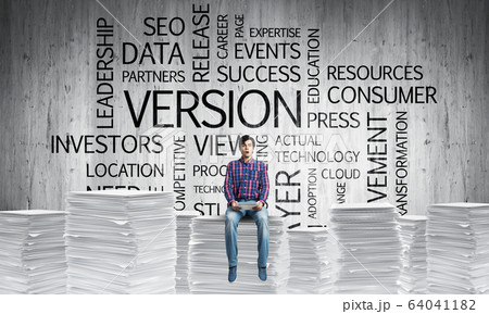 Attractive man sitting on pile of paper documents. Attractive man sitting on pile of paper documents. 64041182