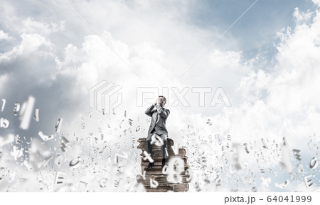 Young man floating in sky and do not want to see anything 64041999