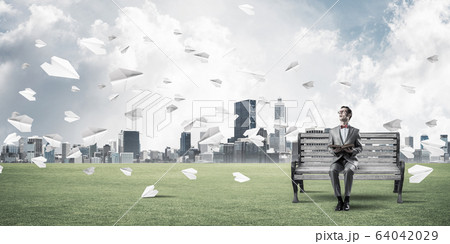 Young businessman or student studying the science and paper plan 64042029