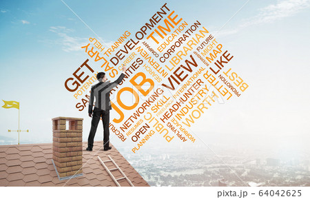 Young businessman standing on house roof and writing leadership skill concept. Mixed media 64042625