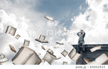 Young man sitting on top and dont want to hear anything 64042635