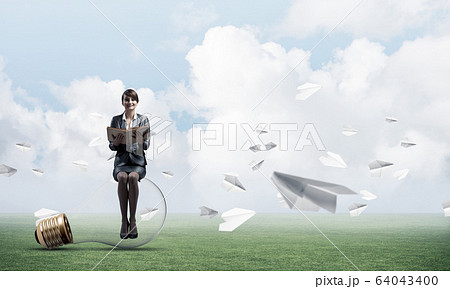 Young woman holding open book Young woman holding open book 64043400