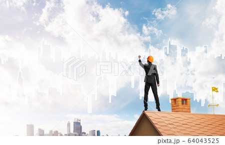 Man architect draw silhouette of modern city on blue sky. Mixed media Man architect draw silhouette of modern city on blue sky. Mixed media 64043525