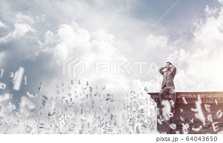 Young man on building edge dont want to hear anything 64043650