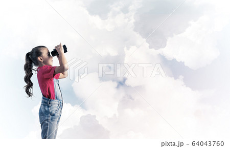 Concept of careless happy childhood with girl looking in binocul Concept of careless happy childhood with girl looking in binocul 64043760