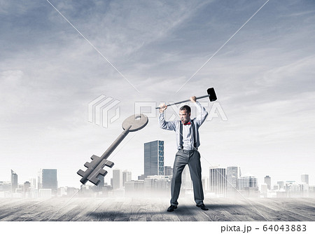 Breaking through access concept with furious man crashing concre Breaking through access concept with furious man crashing concre 64043883