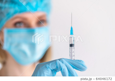 Syringe for injection in nurse hand. Medical glass Syringe for injection in nurse hand. Medical glass 64046172