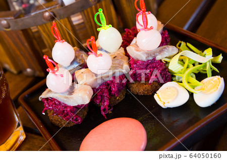 Canapes of pickled herring with beets Canapes of pickled herring with beets 64050160