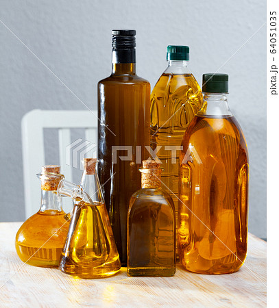Vegetable oil on wooden table Vegetable oil on wooden table 64051035