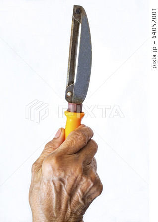 Senior woman's right hand holding Stainless with plastic orange peeler on white background, Close up shot, Selective focus, Kitchen utensils concept 64052001
