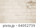 Background of wide cream brick wall texture. Old 64052739