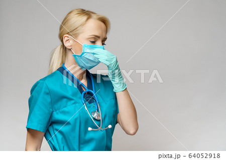 medical doctor nurse woman with stethoscope wearing protective mask and rubber or latex gloves 64052918
