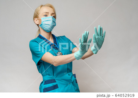 medical doctor nurse woman wearing protective mask and rubber or latex gloves - scared and stressed medical doctor nurse woman wearing protective mask and rubber or latex gloves - scared and stressed 64052919