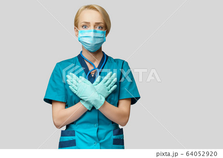medical doctor nurse woman wearing protective mask and rubber or latex gloves - scared and stressed medical doctor nurse woman wearing protective mask and rubber or latex gloves - scared and stressed 64052920