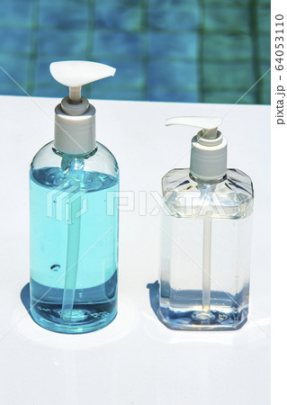 People's hands using portable wash hand sanitizer gel pump dispenser with alcohol gel sanitizer on white & blue, Close up shot, Prevention from covid19, Bacteria, Healthcare, 7 step wash hand People's hands using portable wash hand sanitizer gel pump dispenser with alcohol gel sanitizer on white & blue, Close up shot, Prevention from covid19, Bacteria, Healthcare, 7 step wash hand 64053110