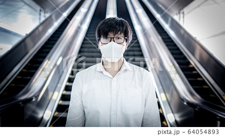 Asian man wearing mask at skytrain station 64054893