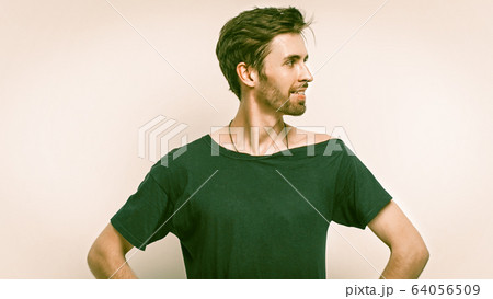 Positive Man With Arms Akimbo On Grey Back 64056509