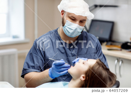 Dentist check-up teeth to young woman patient. 64057209