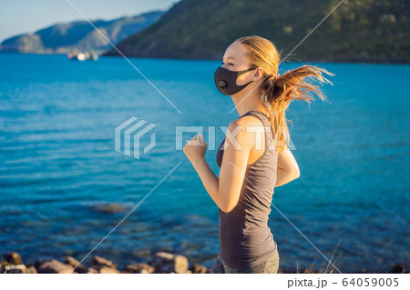 Runner wearing medical mask, Coronavirus pandemic Covid-19. Sport, Active life in quarantine 64059005