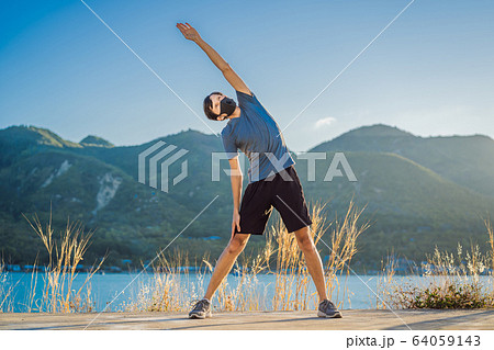 Runner wearing medical mask, Coronavirus pandemic Covid-19. Sport, Active life in quarantine 64059143