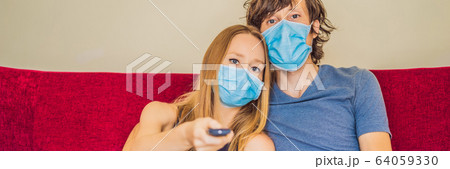 Man and woman are sitting in quarantine, sitting at home and watching TV. Coronavirus, epidemic 64059330