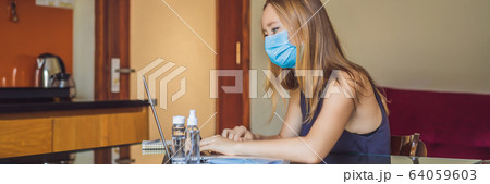 Coronavirus. Young business woman working from home wearing protective mask. Business woman in 64059603
