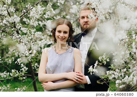 young beautiful couple in the garden against the 64060380