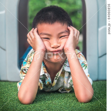 Funny boy coming out of plastic playground with Funny boy coming out of plastic playground with 64060856
