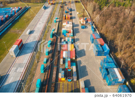 Aerial view of containers loading and unloading at sunset. Top view of container warehouse 64061970