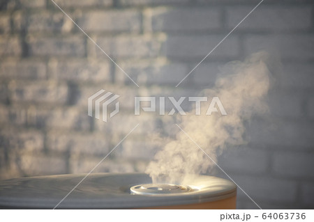 Humidifier spreading steam in the evening with Humidifier spreading steam in the evening with 64063736