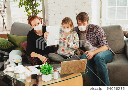 Caucasian family in protective masks and gloves isolated at home with coronavirus symptoms, treatment 64066236