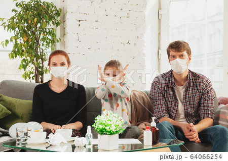 Caucasian family in protective masks and gloves isolated at home with coronavirus symptoms, stop epidemic Caucasian family in protective masks and gloves isolated at home with coronavirus symptoms, stop epidemic 64066254
