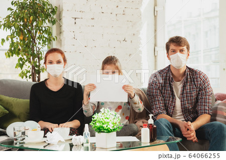 Caucasian family in protective masks and gloves isolated at home with coronavirus symptoms, stop epidemic Caucasian family in protective masks and gloves isolated at home with coronavirus symptoms, stop epidemic 64066255