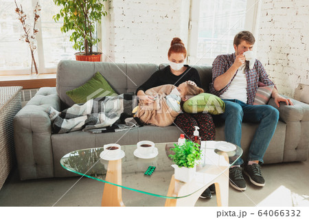 Caucasian family in protective masks and gloves isolated at home with coronavirus symptoms, treatment Caucasian family in protective masks and gloves isolated at home with coronavirus symptoms, treatment 64066332