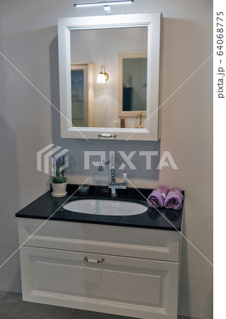 Rectangular mirror on the wall in bathroom Rectangular mirror on the wall in bathroom 64068775