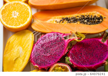 Exotic fruits halves on table 64070241