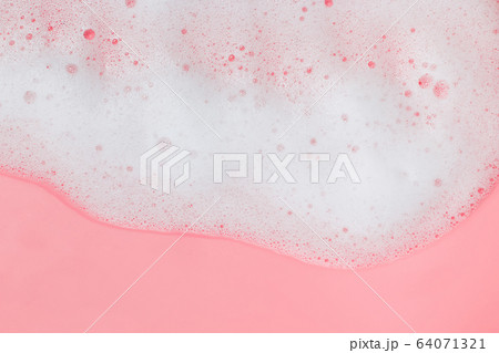 White soap foam on pink background 64071321