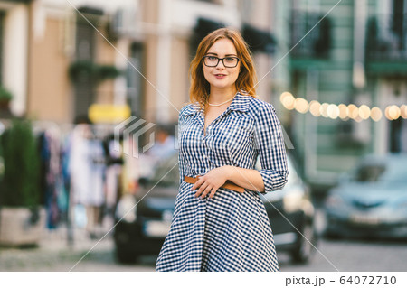 caucasian woman and light bulb with bokeh background. street style fashion. European trip, old city, summer vacation. happy stylish woman at old european city street. Vintage style caucasian woman and light bulb with bokeh background. street style fashion. European trip, old city, summer vacation. happy stylish woman at old european city street. Vintage style 64072710