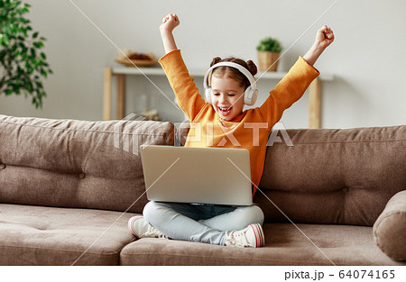 Girl celebrating victory in video game. Girl celebrating victory in video game. 64074165