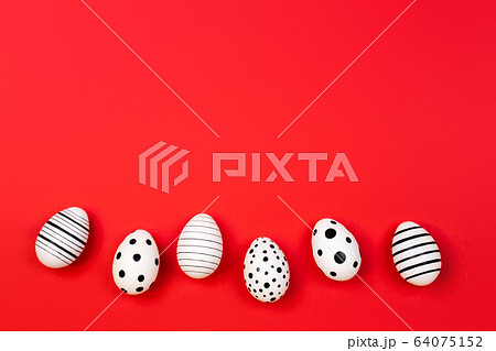Different graphic hand-painted eggs on trendy coral background. 64075152
