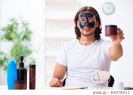 Young male cosmetician recording video for his blog 64076411
