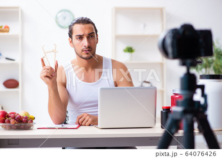 Young male blogger in dieting concept Young male blogger in dieting concept 64076426