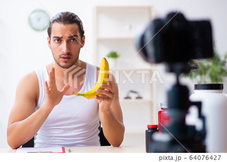 Young male blogger in dieting concept Young male blogger in dieting concept 64076427